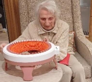 resident with knitting machine