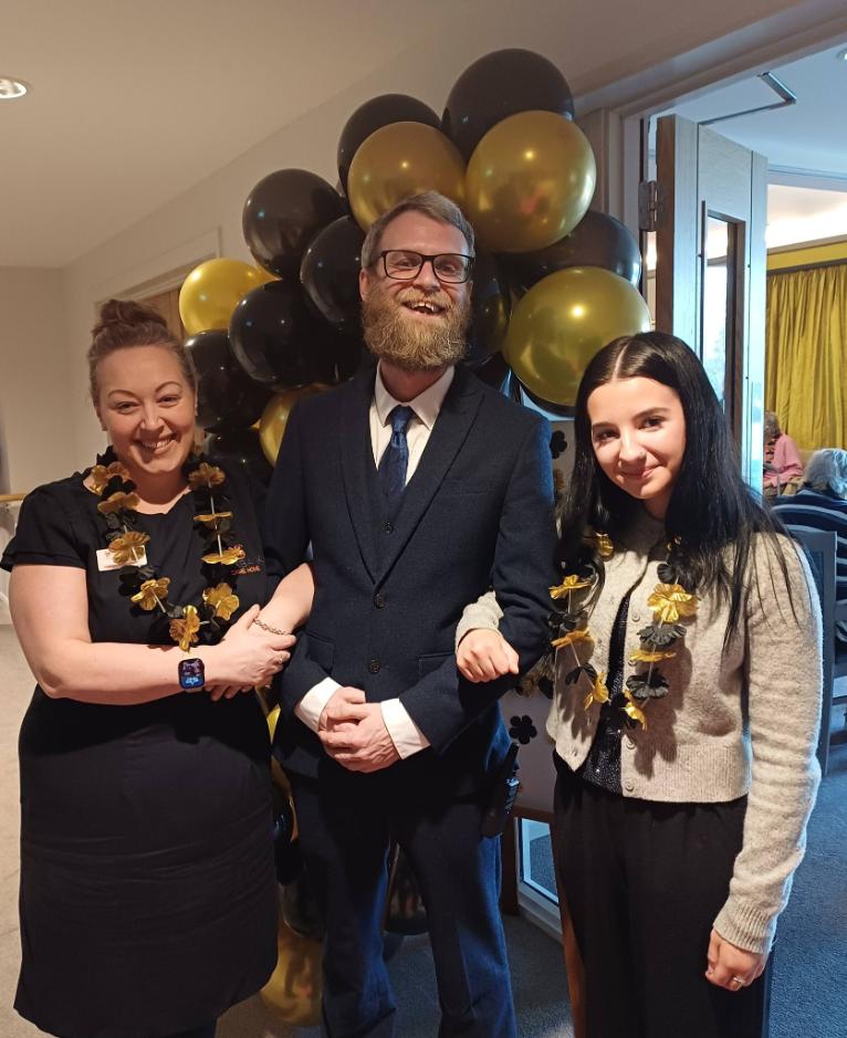 staff welcoming resident to the event 