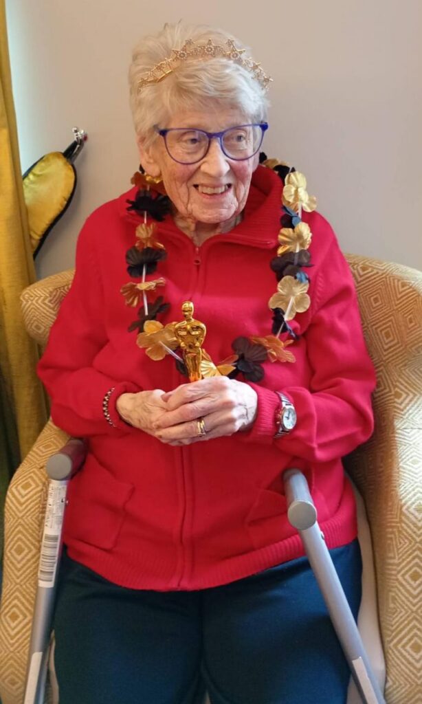 resident receiving an award frmo the home manager 