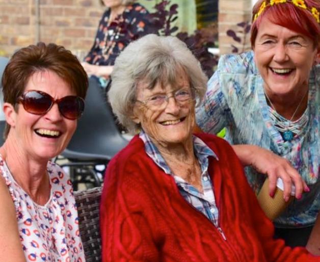 resident with family at event smiling